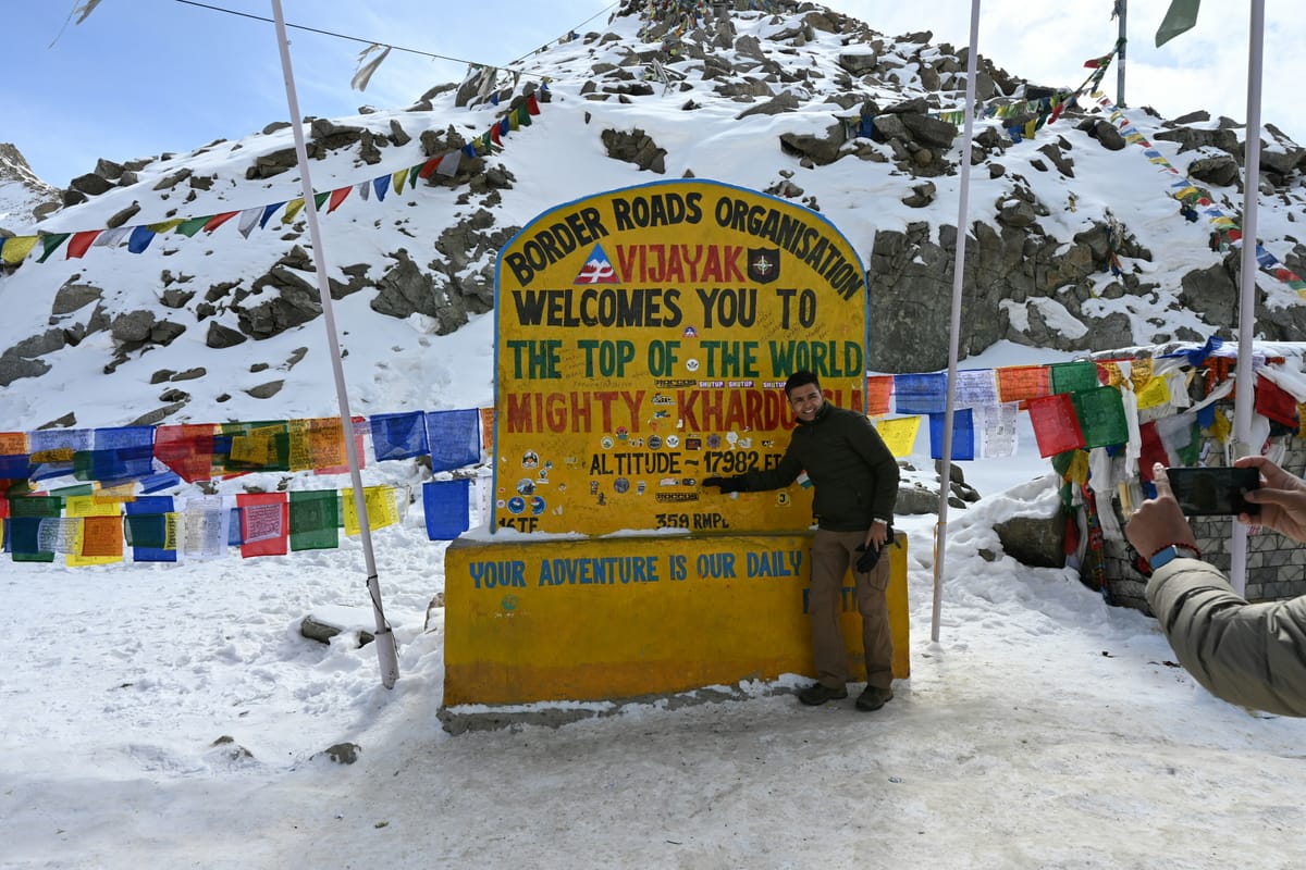 Tourists at the Khardung La pass signboard (18,379 ft), at this altitude UV radiation is 40-50% more intense than at sea level, making sun protection non-negotiable