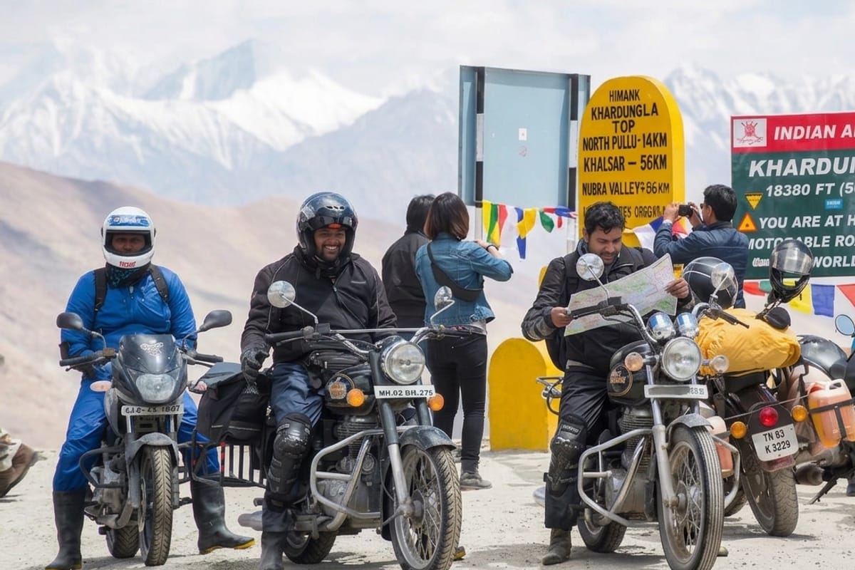 Bikers at the Khardung La pass signboard, at 5,359m one of the highest motor-able passes in the world, the views over the Indus Valley are vast